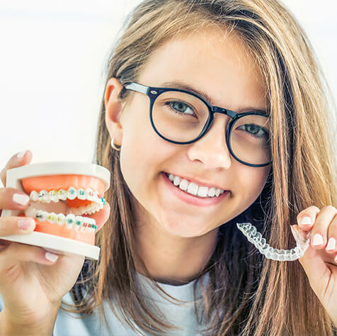 girl with braces and clear aligners