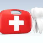 A white tooth floats next to a red first aid kit to indicate a dental emergency