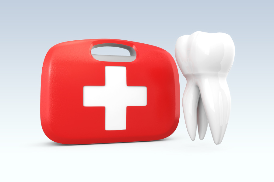 A white tooth floats next to a red first aid kit to indicate a dental emergency