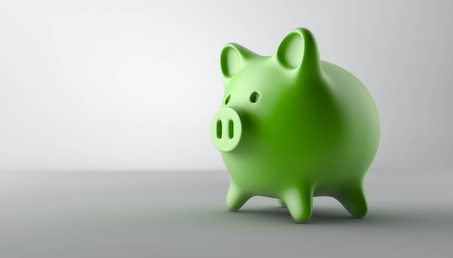 Closeup of a green piggy bank on a gray surface