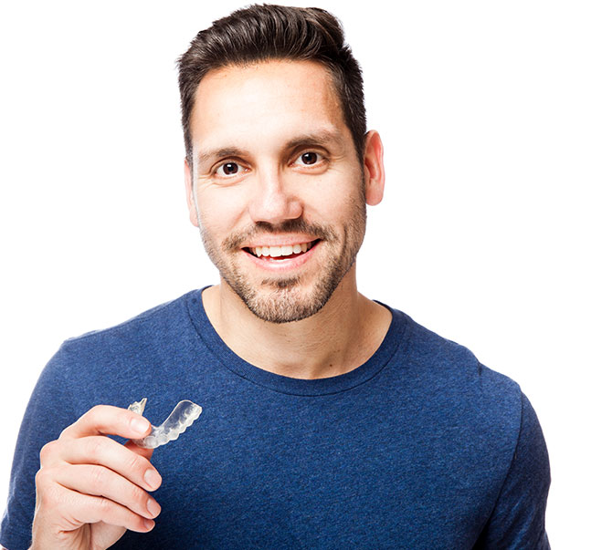 man holding clear aligner