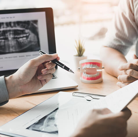 two people discussing dental-related paperwork